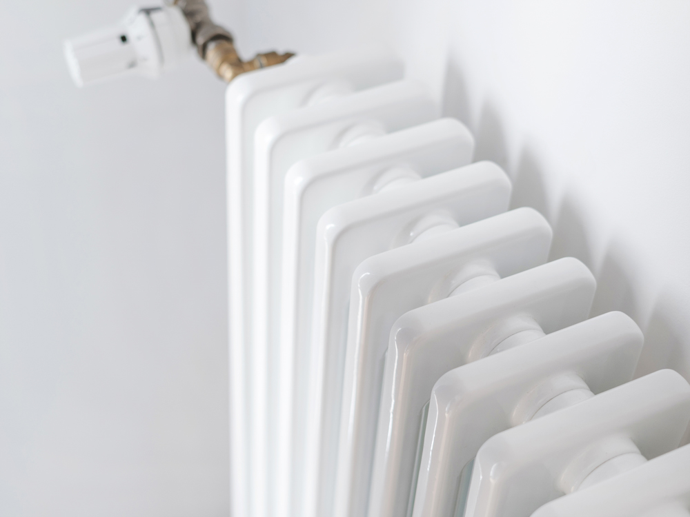 Close-up view of a radiator featuring a hose connected to it, showcasing the intricate details of the components.