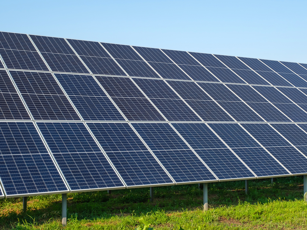 Solar panels installed on a vast field, harnessing sunlight for renewable energy generation.